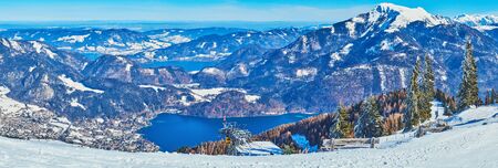 Enjoy the winter vacation in Salzkammergut region, famous for the best Alpine landscapes, comfortable ski areas and pure lakes, such the Wolfgangsee, seen from the snowy peak of Zwolferhorn mount, St Gilgen, Austriaの写真素材