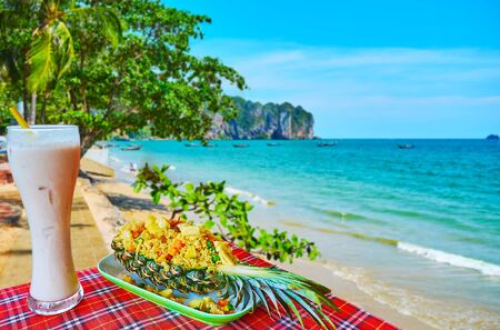 Enjoy the tasty Thai cuisine with a view on Ao Nang beach, taste pineapple fried rice and fresh fruit juice with ice, Krabi, Thailandの写真素材