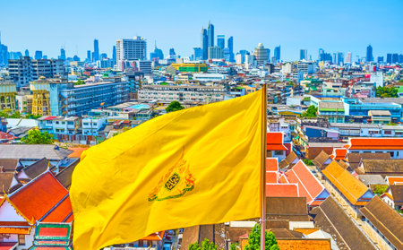 BANGKOK, THAILAND - APRIL 24, 2019: The waving yellow Royal flag on top of Golden Mount with a view...