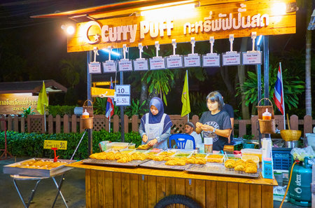 PAI, THAILAND - MAY 5, 2019: Visit Night Market in Walking Street and watch the process of cooking of traditional fried pies and puffs with different fillings and curry, on May 5 in Paiのeditorial素材