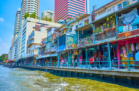 BANGKOK, THAILAND - APRIL 24, 2019: The small clothing market on groung floor of residential houses on the bank of Saen Saep khlong (canal), on April 24 in Bangkokのeditorial素材
