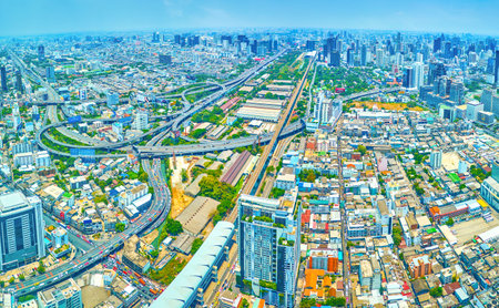 BANGKOK, THAILAND - APRIL 24, 2019: Panorama of modern city with high edifices and large highway intersection, on April 24 in Bangkokのeditorial素材