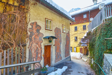 HALLSTATT, AUSTRIA - FEBRUARY 25, 2019: The narrow curved alley of Oberer Marktplatz with old houses, nowadays serving as hotels or stores, on February 25 in Hallstatt.のeditorial素材