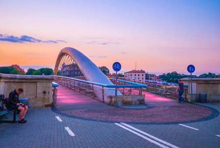 KRAKOW, POLAND - JUNE, 20, 2018: The beautiful modern Father Bernatek Footbridge with bright illuminated walking areas in twilight light, on June 20 in Krakowのeditorial素材