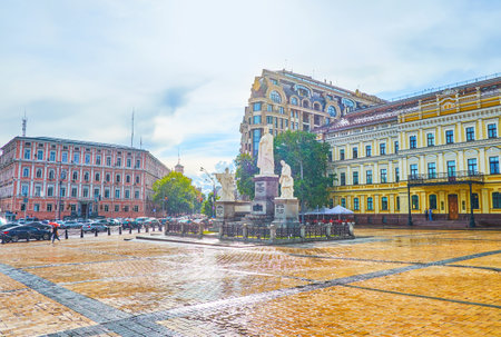 KIEV, UKRAINE - JULY 10, 2019: The pleasant walk under the summer rain in Saint Michael square observing scenic sculpture of the Princess Olga, the ruler in medieval times, on July 10 in Kievのeditorial素材