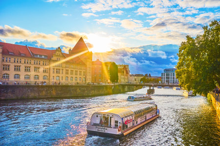 BERLIN, GERMANY - OCTOBER 3, 2019: The leisure boat sightseeing trip along Spree river in the evening time, on October 3 in Berlinのeditorial素材