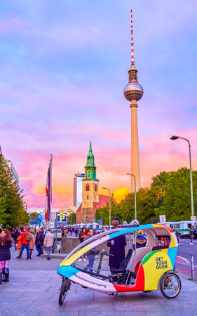 BERLIN, GERMANY - OCTOBER 3, 2019: The small personal cycle rickshaw guided transport waits for the...