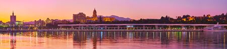 Panorama of sunset over the coast of Malaga with a view on the main city landmarks (Cathedral, Alcazaba fortress and Gibralfaro castle) behind the port, Costa del Sol, Spainの写真素材