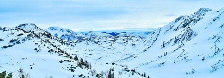Panoramic snowy scenery of Feuerkogel mountain plateau, the famous resort, popular among the snowboarders, skiers, snowshoers and other sportsmen, Ebensee, Salzkammergut, Austriaの写真素材