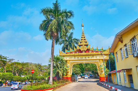 YANGON, MYANMAR - FEBRUARY 17, 2018: The picturesque gate of Mahavijaya (Maha Wizaya) Pagoda with multistaged pyathat roof, carved decors and sculptures, located in Shwedagon Pagoda Road, on February 17 in Yangon.のeditorial素材