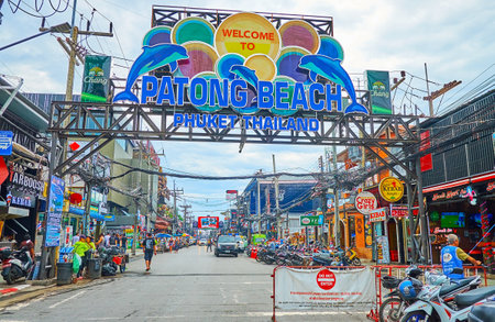 PATONG, THAILAND - MAY 1, 2019: The Bangla walking street entrance with colorful sign on the metal gateway and numerous night clubs and restaurants on the both sides, on May 1 in Patongのeditorial素材
