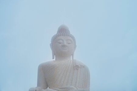 The hard mist covers the image of Ming Mongkol Buddha (Big Buddha), located atop the Nakkerd Hill, Chalong, Phuket, Thailandの写真素材