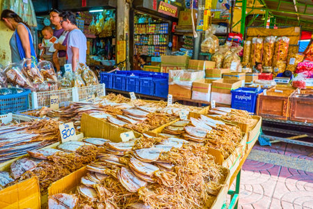 BANGKOK, THAILAND - MAY 12, 2019: The heaps of dried fish, squids and other seafood in outdoor stall of the food market in Mangkon Road of Chinatown, on May 12 in Bangkokのeditorial素材