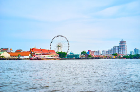 BANGKOK, THAILAND - APRIL 15, 2019: The great view on the Asiatique amusement park with the large Ferris wheel from the passing river boat, on April 15 in Bangkokのeditorial素材