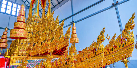 BANGKOK, THAILAND - APRIL 15, 2019: The scenic wooden carved decorations of the Royal Chariots with heads of Nagas in National Museum, on April 15 in Bangkokのeditorial素材