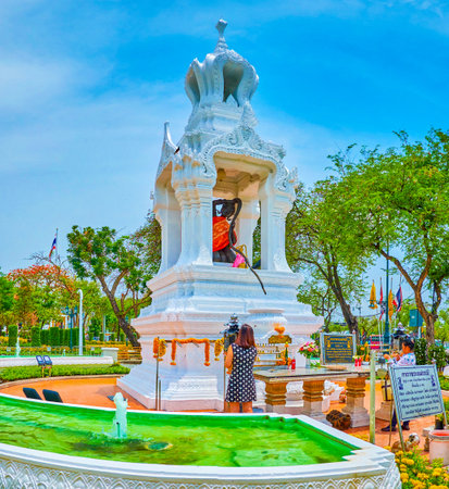 BANGKOK, THAILAND - APRIL 15, 2019: The small carved shrine with the sculpture of the goddess Mother Earth with long hair, on April 15 in Bangkokのeditorial素材
