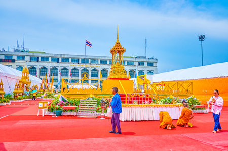 BANGKOK, THAILAND - APRIL 15, 2019: The monks pray at the mandop located between pavilions of religion goods fair on Lan Khon Mueang Town Square, on April 15 in Bangkokのeditorial素材