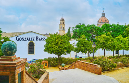 JEREZ, SPAIN - SEPTEMBER 20, 2019: Enjoy the scenic green Alcazar park, located between the medieval fortress and historical Bodegas Gonzalez Byass winery, on September 20 in Jerezのeditorial素材