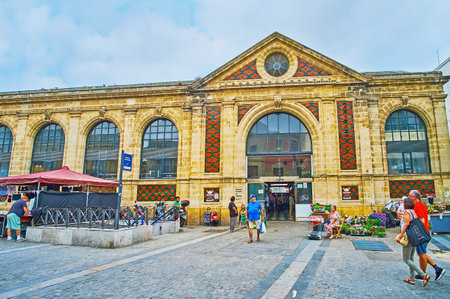 JEREZ, SPAIN - SEPTEMBER 20, 2019: The facade of historical Abastos Central Market building with geometric tile panels, large arched entrance and windows on the stone wall, on September 20 in Jerezのeditorial素材