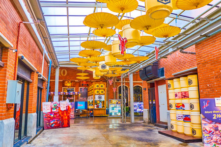 BANGKOK, THAILAND - APRIL 15, 2019: The yellow umbrellas hanged in covered alley in dining department of Asiatique amusement park, on April 15 in Bangkokのeditorial素材