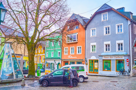 GMUNDEN, AUSTRIA - FEBRUARY 22, 2019: The modestly decorated high historical edifices in small Rinnholzplatz Square with covered old fountain, on February 22 in Gmundenのeditorial素材