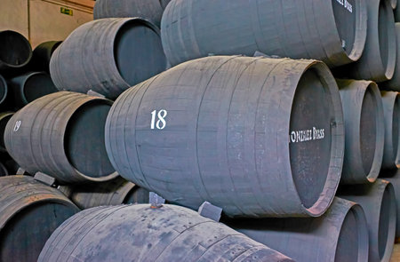 JEREZ, SPAIN - SEPTEMBER 20, 2019: The rows of old oak casks with sherry wine in Bodegas Tio Pepe...