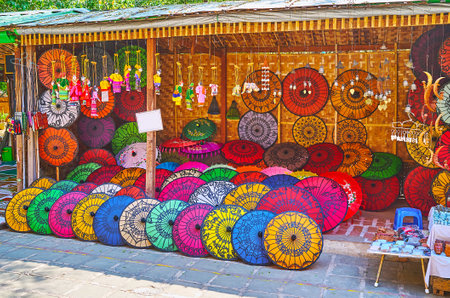 The market pavilion offers traditional Burmese summer umbrellas, decorated with bright colors and fine painted patterns, Htilominlo Temple, Bagan, Myanmarのeditorial素材