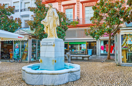 CADIZ, SPAIN - SEPTEMBER 20, 2019: The scenic marble statue and fountain amid the flower stalls of Plaza de Las Flores (Flower Square) in Old Town, on September 20 in Cadizのeditorial素材