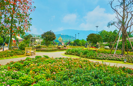 CHIANG MAI, THAILAND - MAY 7, 2019: The colorful flower beds of Homage garden, located on territory of Rajapruek Royal park, decorated with installtion, garden sculptures and Royal Emblem, on May 7 in Chiang Maiのeditorial素材