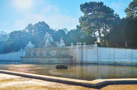 VIENNA, AUSTRIA - FEBRUARY 19, 2019: The light winter morning haze covers Neptune fountain, located in garden of Schonbrunn palace, on February 19 in Viennaのeditorial素材