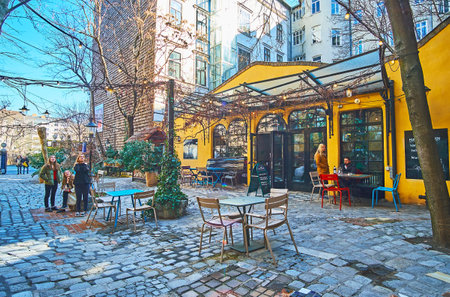 VIENNA, AUSTRIA - FEBRUARY 19, 2019: The small cafe in courtyard of Hundertwasser museum (Kunst Haus Wien), with shady terrace and small tables, on February 19 in Viennaのeditorial素材