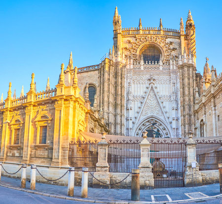 The amazing Puerta De San Cristobal of Seville cathedral with stone carved decorations on its facade in Gothic style, Spainのeditorial素材