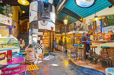 VIENNA, AUSTRIA - FEBRUARY 19, 2019: Interior of Hundertwasser Village - the covered market, with lounge bar amid the stalls and handicraft workshops, on February 19 in Viennaのeditorial素材