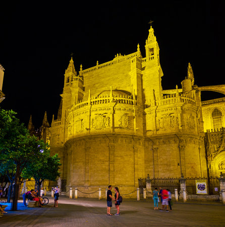 SEVILLE, SPAIN - OCTOBER 1, 2019: The pleasant evening walk in old Seville in surrounding of magnificent illuminated medieval landmarks, such as the Cathedral, on October 1 in Sevilleのeditorial素材