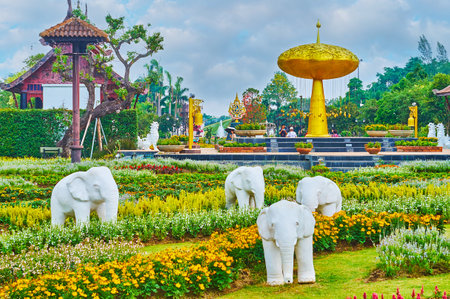 CHIANG MAI, THAILAND - MAY 7, 2019: The white elephants sculptural group in front of the symbol of Rajapruek park - the golden shower tree, on May 7 in Chiang Maiのeditorial素材