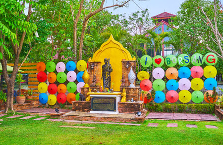 BORSANG, THAILAND - MAY 7, 2019: The statue of Phra In Tha Bhikkhu monk with parasol, surrounded by colorful handmade paper umbrellas - the symbol of craft village, on May 7 in Borsangのeditorial素材