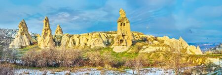 Amazing nature of Cappadocia attracts people to walk among the fairy chimney rocks, caves, tuff cliffs and old cut buildings or to fly on hot air balloon and watch the sceneries from the top, Turkeyの写真素材