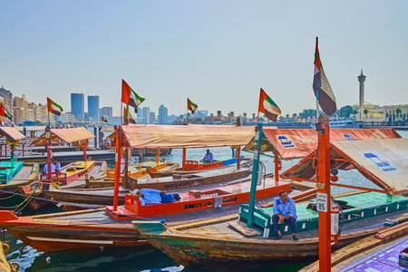 DUBAI, UAE - MARCH 2, 2020: The line of passenger abra boats, moored at the bank of Dubai Creek in Deira district, on March 2 in Dubaiのeditorial素材