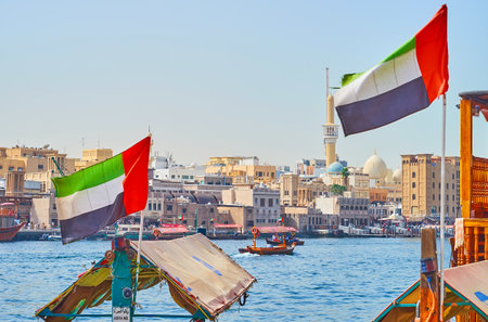 DUBAI, UAE - MARCH 2, 2020: The old housing of Bur Dubai district with a view on abra boats,...