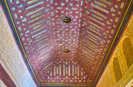 GRANADA, SPAIN - SEPTEMBER 25, 2019:  Islamic style decoration of Gilded Room of Nasrid Palace of Alhambra with carved wooden details, sebka on walls, painted panels on ceiling, on September 25 in Granadaのeditorial素材