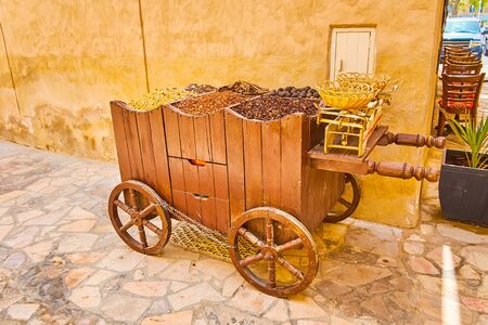 The vintage food cart with spices, nuts, hibiscus tea, cinnamon and weighing scale, Al Fahidi,...