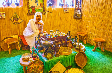 DUBAI, UAE - MARCH 2, 2020: Visit Ethiopian coffee ceremony in Coffee museum and try hot coffee, made in jebena pot and serving with popcorn by Ethiopian woman in national attire, on March 2 in Dubaiのeditorial素材