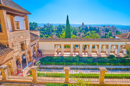 GRANADA, SPAIN - SEPTEMBER 25, 2019: Enjoy the top view on Patio of  Irrigation Ditch of Generalife with arcade, garden, fountain and Alhambra fortress on background, on September 25 in Granadaのeditorial素材