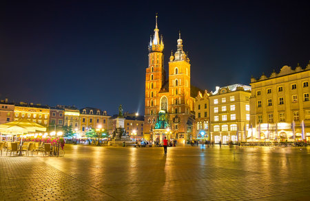 The beautiful night illumination of ensemble of the Rynek Glowny square with its main shrine, the St Mary Basilica, Krakow, Polandのeditorial素材