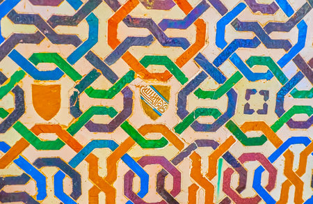 GRANADA, SPAIN - SEPTEMBER 25, 2019: The colorful tile geometric pattern on wall of Palace of Lions (Nasrid Palace, Alhambra), on September 25 in Granadaのeditorial素材