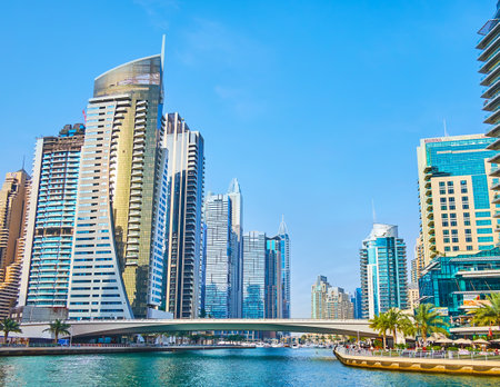 DUBAI, UAE - MARCH 2, 2020: The view on Dubai Marina canal with Al Emreef bridge across it and luxury living skyscrapers on both banks, on March 2 in Dubaiのeditorial素材