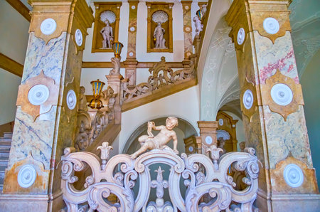 SALZBURG, AUSTRIA - MARCH 1, 2019: The stone sculptures of putti and other antique characters are the famous decorative elements of staircases of Mirabell Palace, on March 1 in Salzburgのeditorial素材