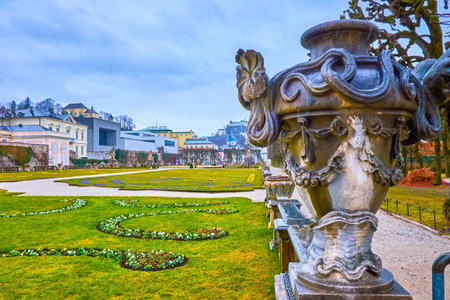 SALZBURG, AUSTRIA - MARCH 1, 2019: Mirabell Garden complex boasts scenic flower beds and large carved vases in Antique style, arranged throughout the park, on March 1 in Salzburgのeditorial素材
