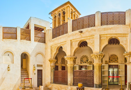 DUBAI, UAE - MARCH 2, 2020: The courtyard of Architectural Heritage Society mansion, located in in Al Bastakiya (Al Fahidi) historical district and decorated with carved columns, arcade and wooden terrace, on March 2 in Dubaiのeditorial素材