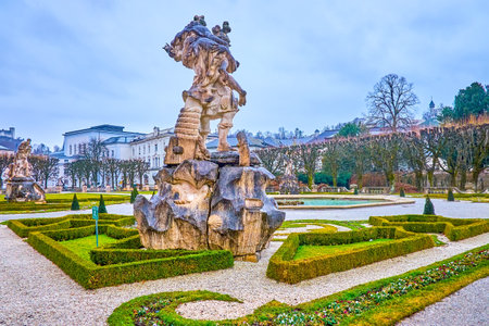 SALZBURG, AUSTRIA - MARCH 1, 2019: The sculptural composition on antique theme, Paris steals Helena, located around central fountain of Mirabell Gardens, on March 1 in Salzburgのeditorial素材